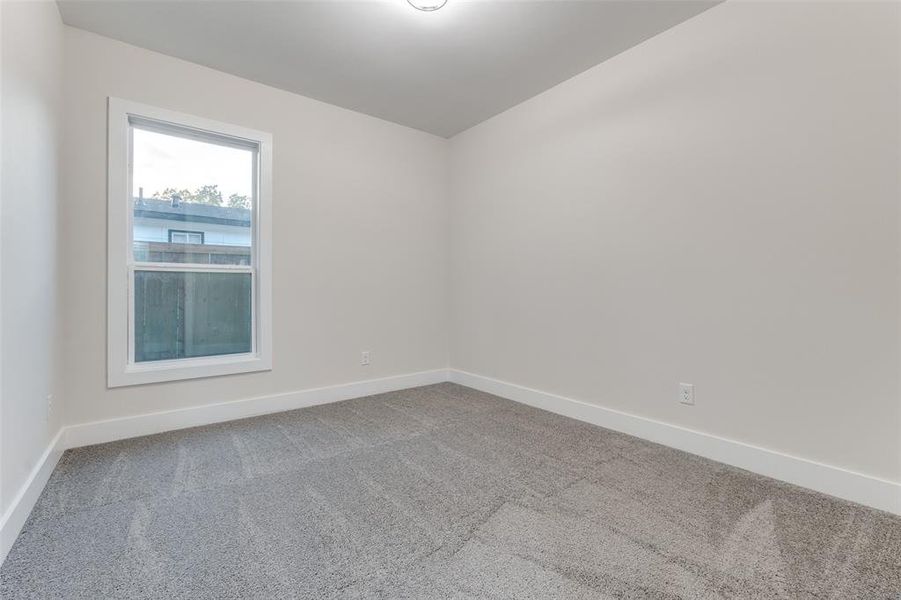 Beautiful guest bedroom with plenty of natural lighting.