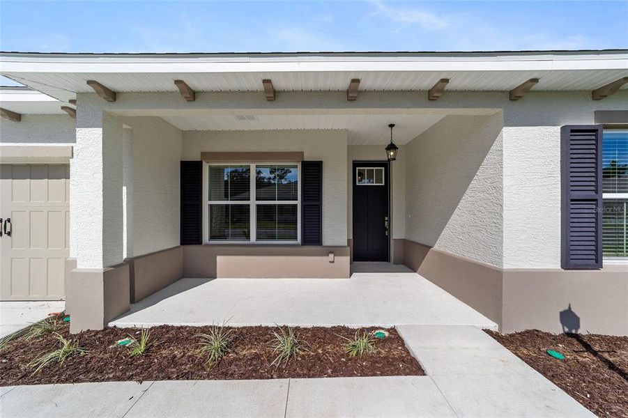 Exterior details and patio area of a home in On Top of the World Communities, Ocala (Image 3).