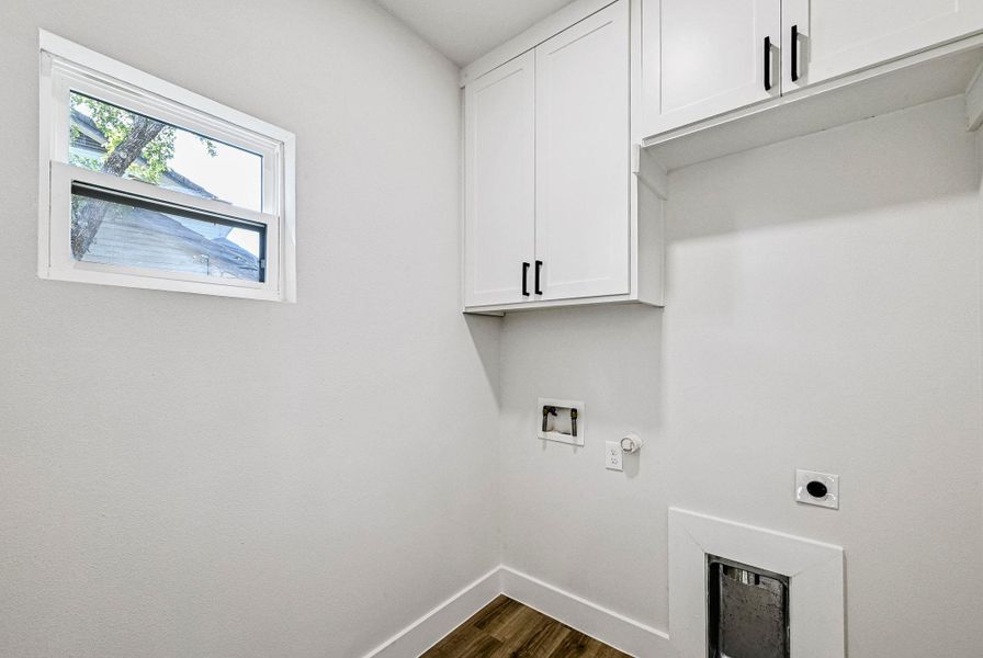 Washroom featuring dark wood-style floors, cabinet space, hookup for a gas dryer, electric dryer hookup, and washer hookup