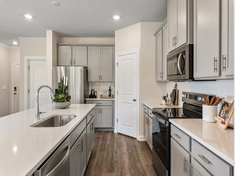 The well-appointed kitchen with a large island and generous pantry size makes meal prep a breeze.