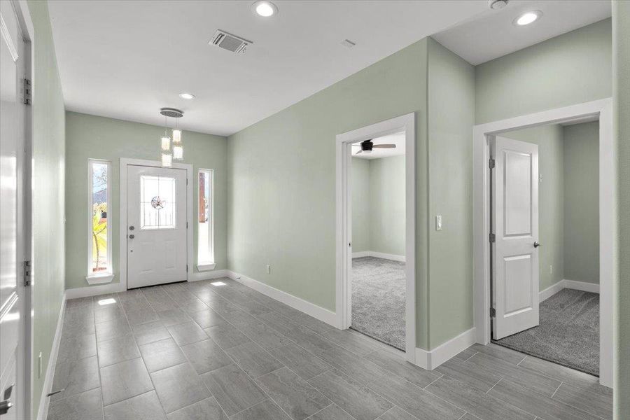 Entryway with recessed lighting and wood finish floors