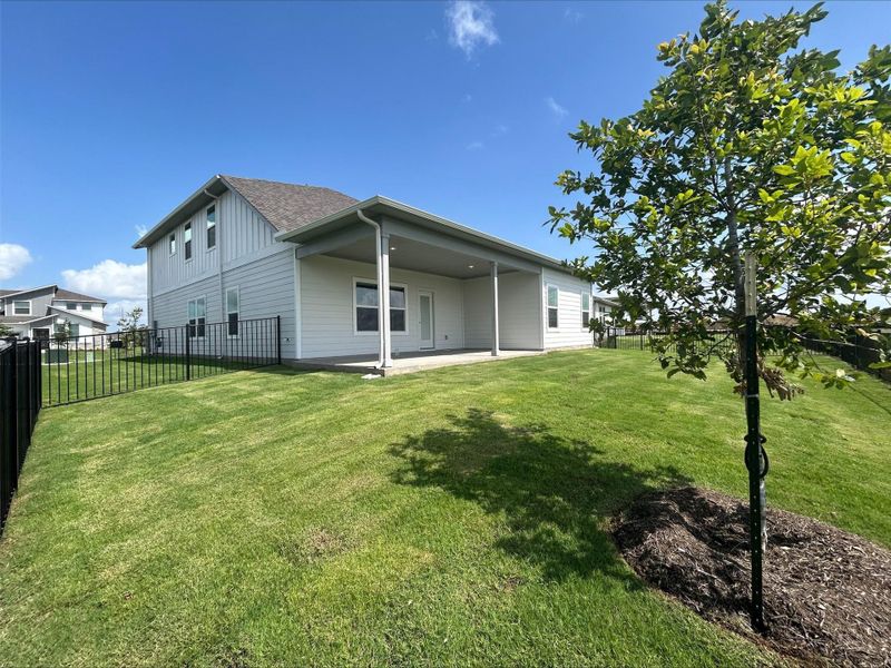 Back of house featuring a patio and a shingled roof Back of house featuring a patio and a shingled roof