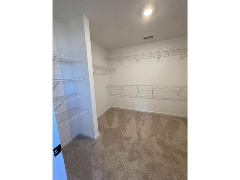 This spacious walk-in closet offers extensive stor