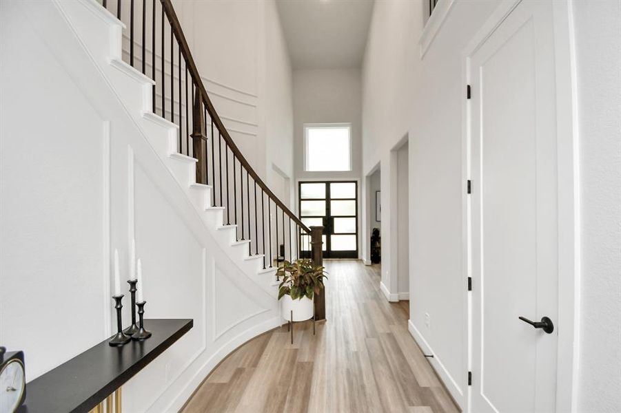 Entering through the modern double doors, you are greeted by soaring ceilings, beautiful Spiral Stairs and luxury vinyl plank flooring.