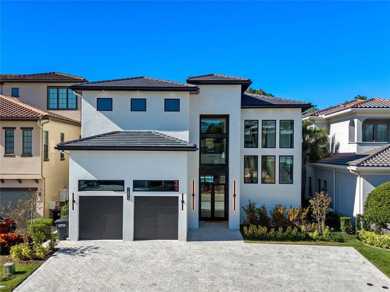 Front exterior of a new home in , Reunion, FL, highlighting curb appeal (Image 2). Front exterior of a new home in , Reunion, FL, highlighting curb appeal (Image 2).
