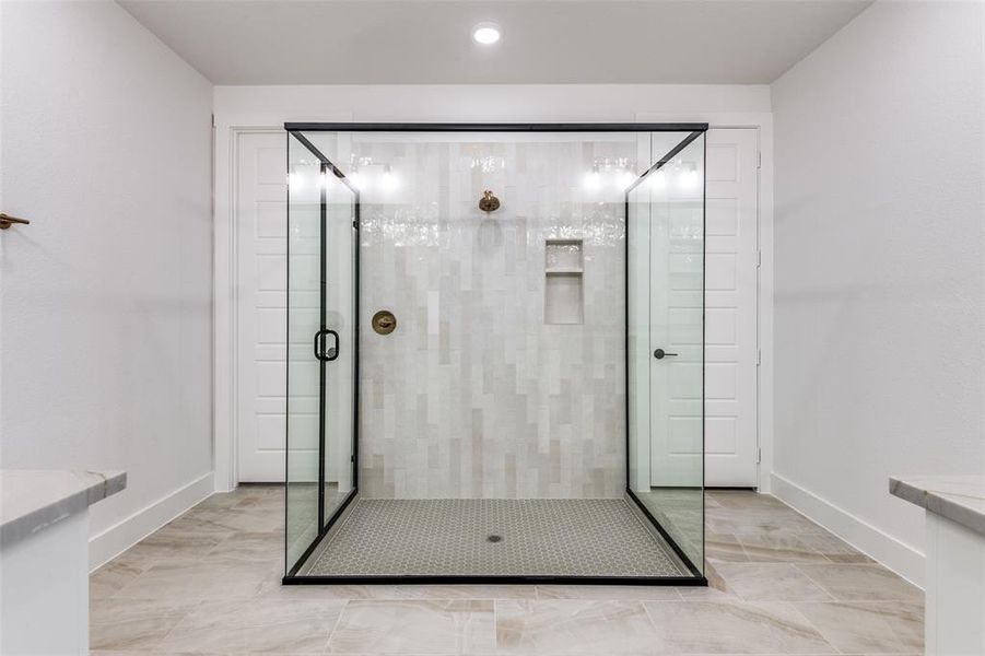 Bathroom with tile patterned flooring and walk in shower