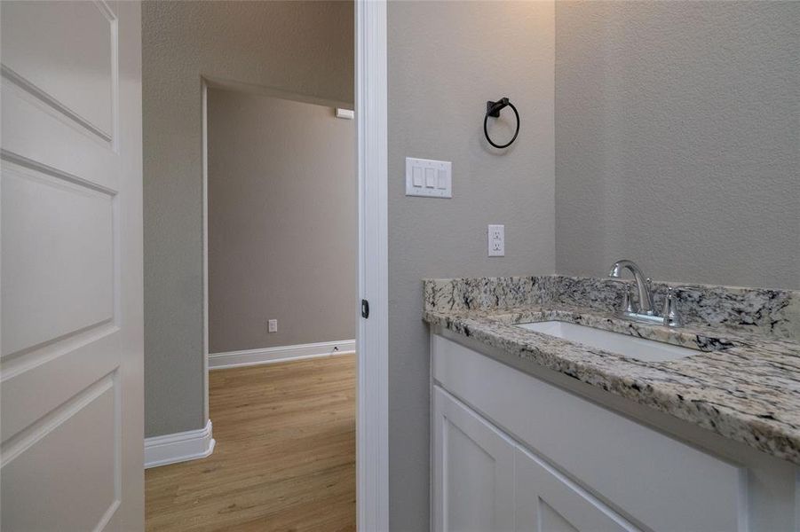 Bathroom with vanity and wood-type flooring