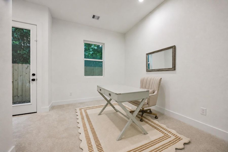 Versatile and inviting, the first-floor bedroom is equally suited as a guest suite or home office, with direct access to the backyard. We'll explore the outdoor space shortly. Versatile and inviting, the first-floor bedroom is equally suited as a guest suite or home office, with direct access to the backyard. We'll explore the outdoor space shortly.