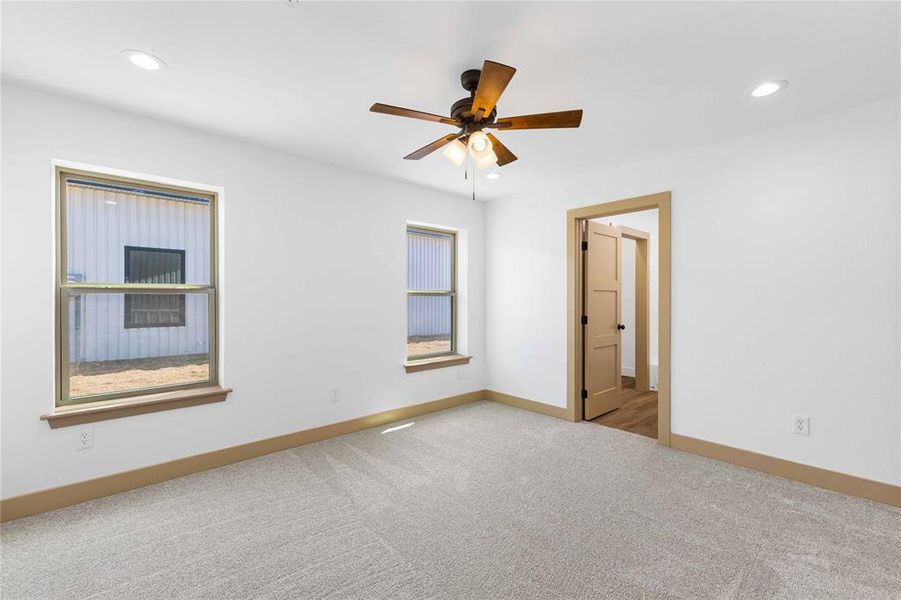 Carpeted empty room with recessed lighting and ceiling fan