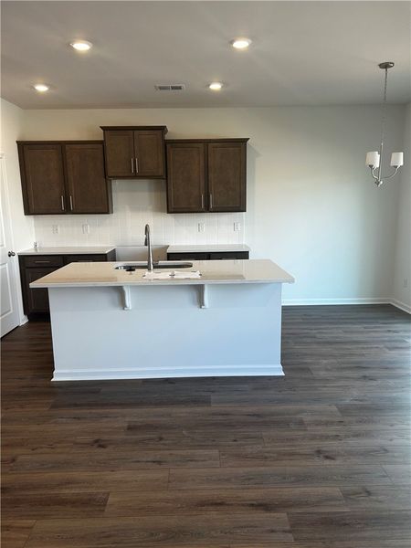 This modern kitchen features rich cabinetry, sleek
