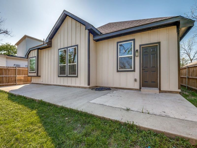 Back of property featuring board and batten siding, a patio area, and fence Back of property featuring board and batten siding, a patio area, and fence