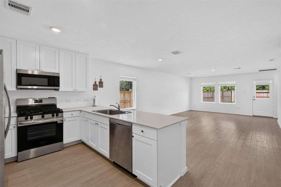 From the kitchen, you can stay connected to the activity happening throughout the main living space.