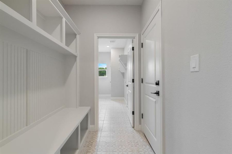 Mudroom with light tile flooring