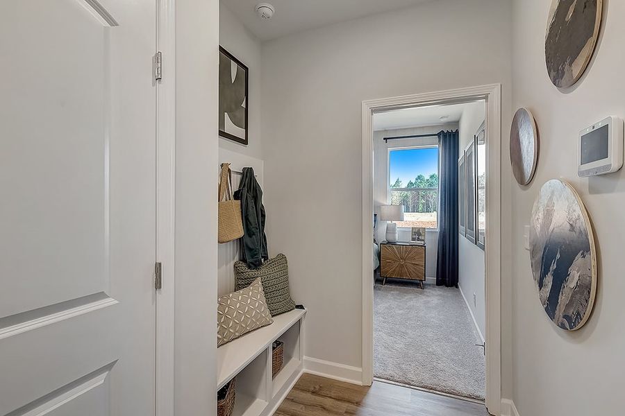 A room with a bed and a mirror.