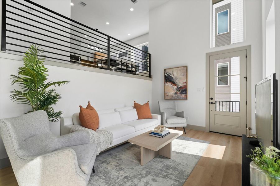 Enjoy a bright, modern living space with durable SPC flooring and a stunning visual connection to the dining area above—bringing style and function together across split levels. Enjoy a bright, modern living space with durable SPC flooring and a stunning visual connection to the dining area above—bringing style and function together across split levels.