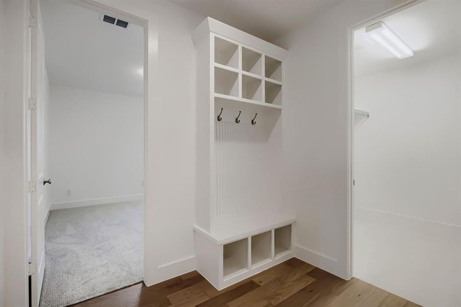 Built-in storage unit featuring cubbies, shelving, and coat hooks