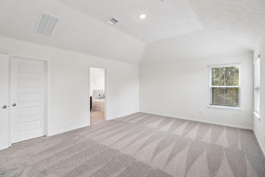 Additional view from primary suite to walk-in closet and primary bathroom