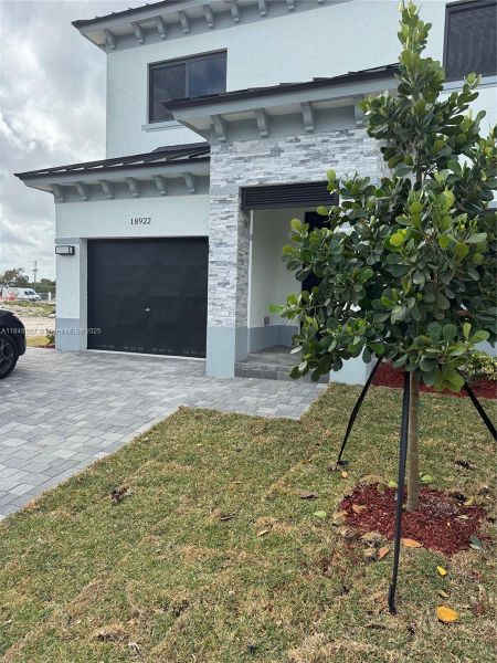 Front exterior of a new home in , Homestead, FL, highlighting curb appeal (Image 2).