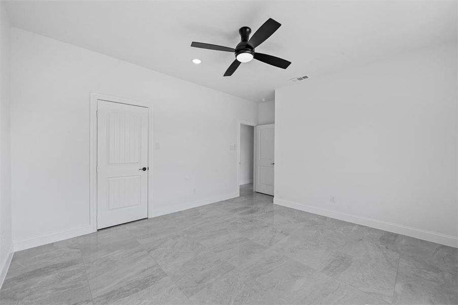 Unfurnished bedroom featuring ceiling fan and light tile patterned floors