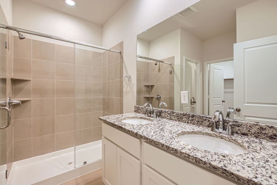 A bathroom with a large mirror.