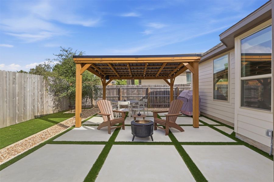 A customized paver patio under a handsome wooden pavilion anchors this backyard space.
