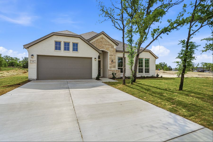 Front exterior of a new home in Arbor Oaks, Boyd, TX, highlighting curb appeal (Image 29). Front exterior of a new home in Arbor Oaks, Boyd, TX, highlighting curb appeal (Image 29).