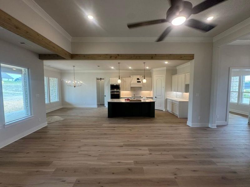 Spacious interior featuring wood-finish flooring, recessed lighting, and a contemporary ceiling fan Spacious interior featuring wood-finish flooring, recessed lighting, and a contemporary ceiling fan