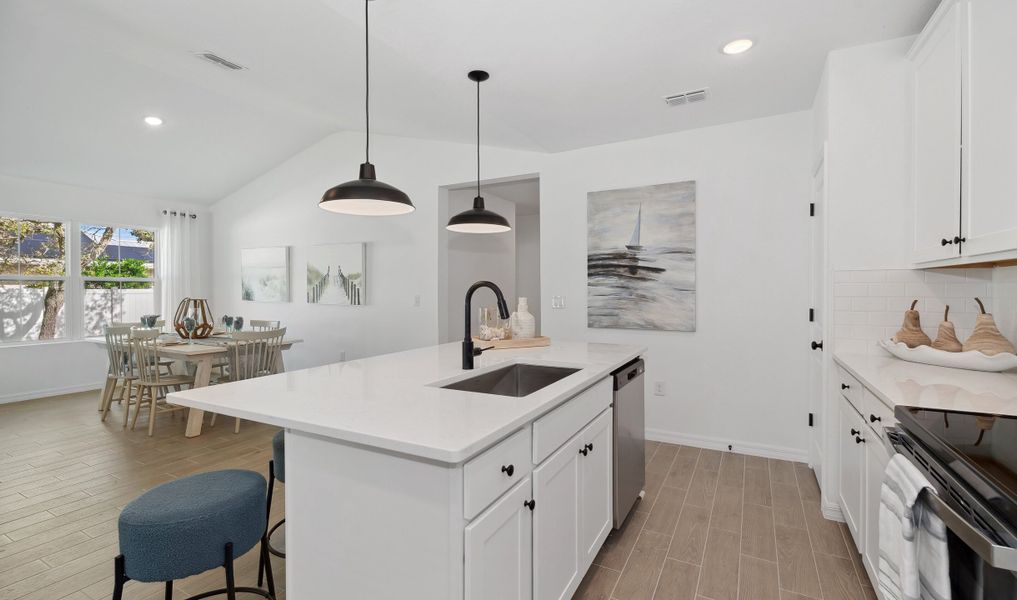 Charming kitchen with pendant lighting over island