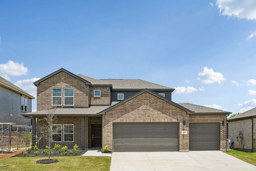 Front exterior of a new home in Overland Grove, Forney, TX, highlighting curb appeal (Image 1). Front exterior of a new home in Overland Grove, Forney, TX, highlighting curb appeal (Image 1).