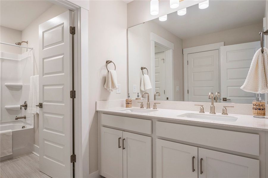 This bathroom features a double vanity with ample This bathroom features a double vanity with ample
