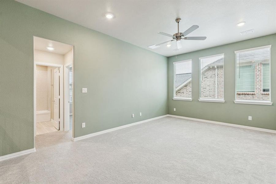 Spare room with carpet flooring, a ceiling fan, and recessed lighting