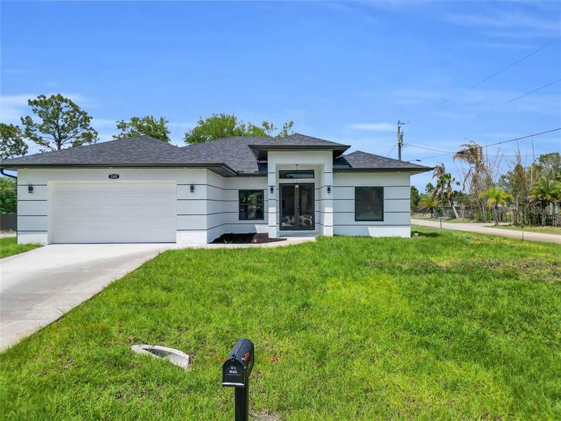 Front exterior of a new home in , Lehigh Acres, FL, highlighting curb appeal (Image 17).