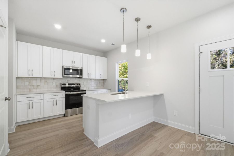 Designer tile in kitchen and both baths
