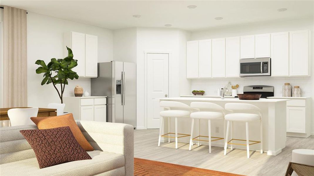 Kitchen with an island with sink, a breakfast bar area, white cabinets, backsplash, and stainless steel appliances