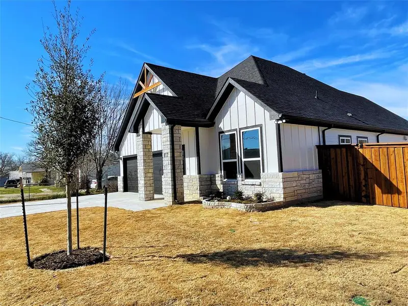 View of front of property with a garage and a front yard