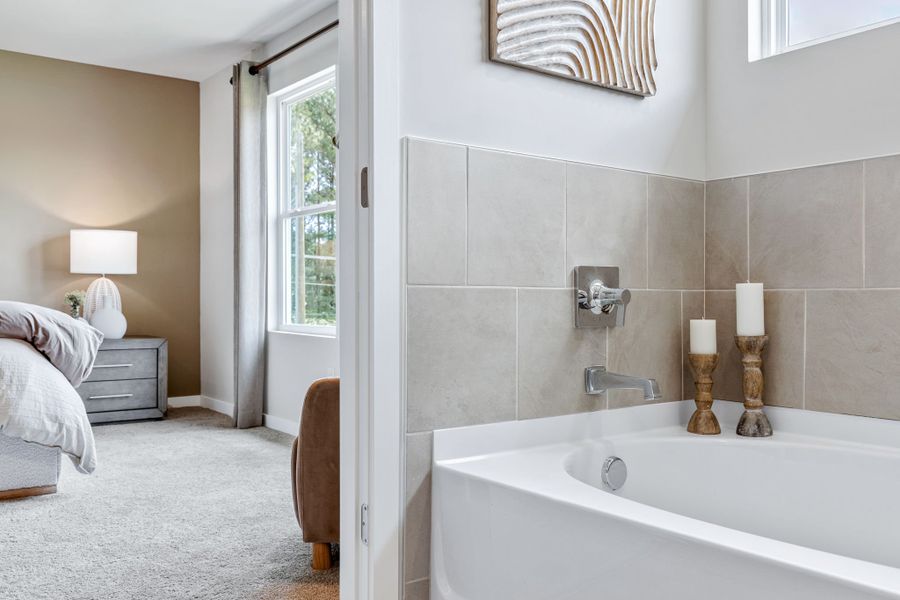 A bathroom with a tub and a sink. A bathroom with a tub and a sink.