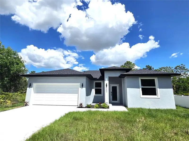 Front exterior of a new home in , Port Charlotte, FL, highlighting curb appeal (Image 15).