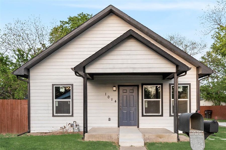 View of front of property with covered porch and heating fuel