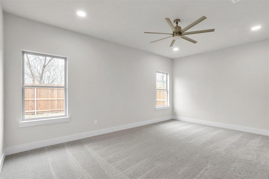 Unfurnished room featuring ceiling fan and carpet floors