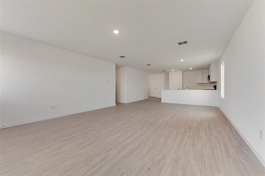 Unfurnished living room featuring light wood-type flooring