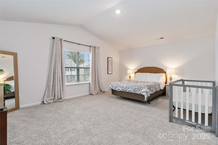 Primary bedroom with cathedral ceiling