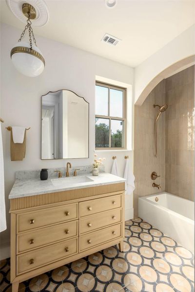 An arched shower alcove and patterned tile flooring highlight this bathroom design. An arched shower alcove and patterned tile flooring highlight this bathroom design.