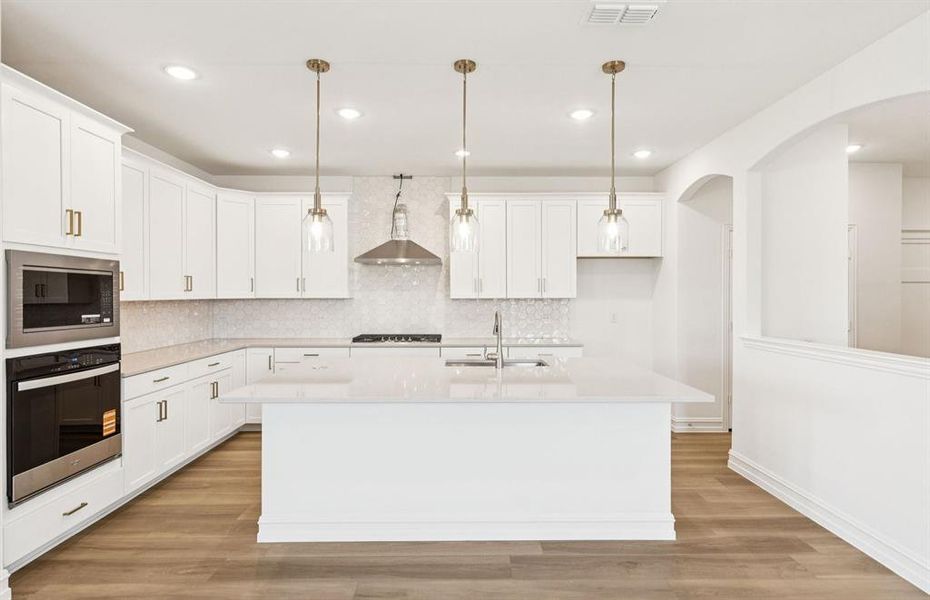 Bright kitchen with an expansive center island perfect for gatherings Bright kitchen with an expansive center island perfect for gatherings