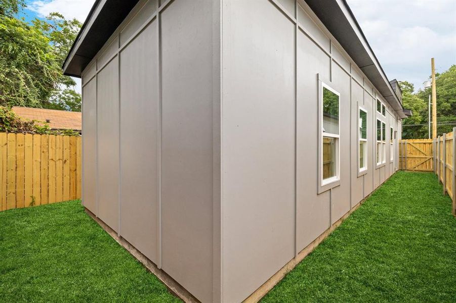 View of property exterior featuring a fenced backyard