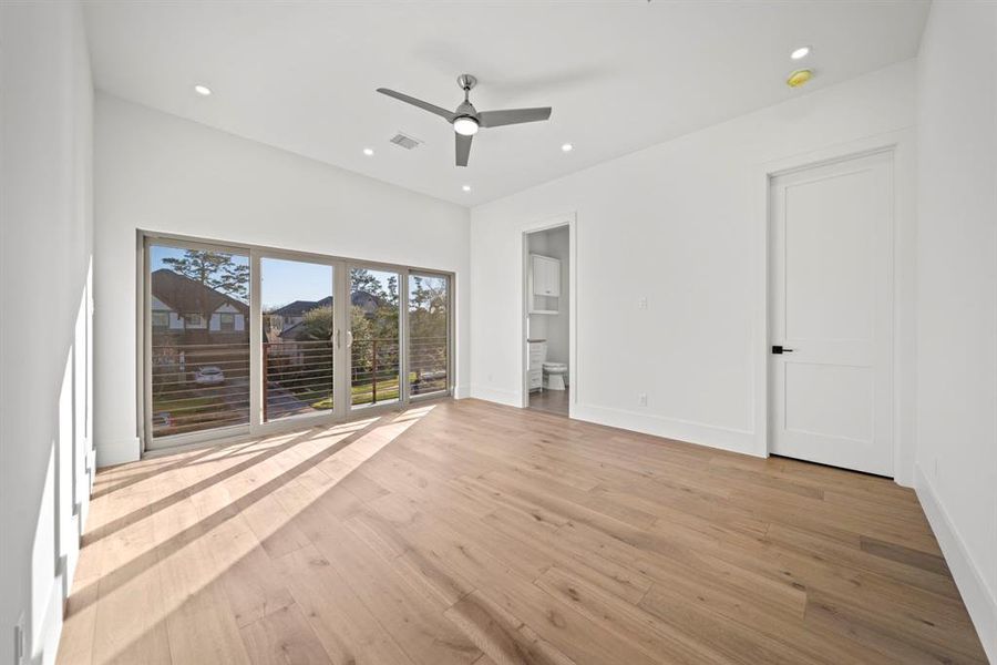 This bright and airy second bedroom features stunning wood flooring, recessed lighting, and a sleek ceiling fan for added comfort. The sliding glass doors open to a private balcony, offering beautiful views and a seamless indoor-outdoor living experience. Complete with an ensuite bathroom, this bedroom provides a perfect combination of luxury and privacy for its occupant.