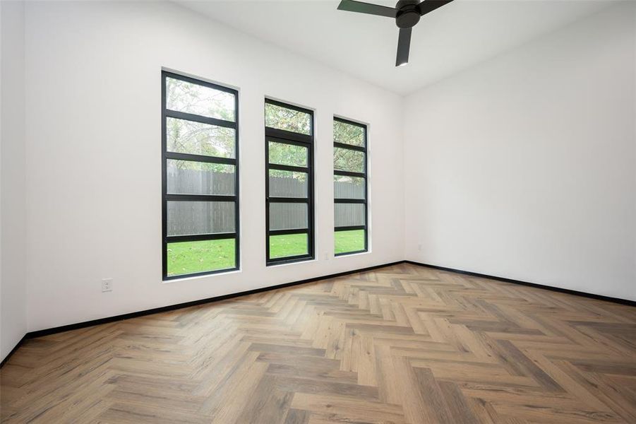 Spare room featuring a ceiling fan and baseboards Spare room featuring a ceiling fan and baseboards