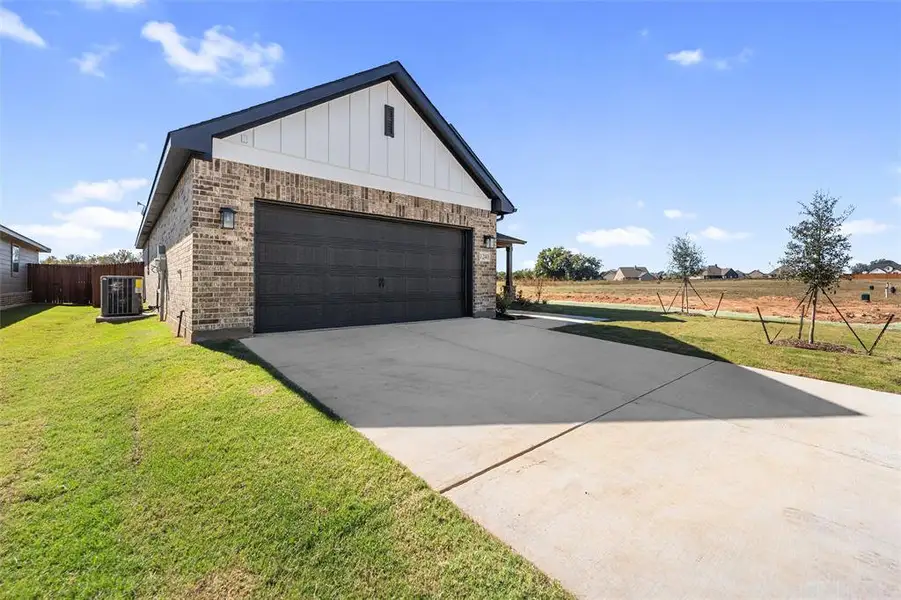 Front exterior of a new home in Covenant Park, Springtown, TX, highlighting curb appeal (Image 1). Front exterior of a new home in Covenant Park, Springtown, TX, highlighting curb appeal (Image 1).