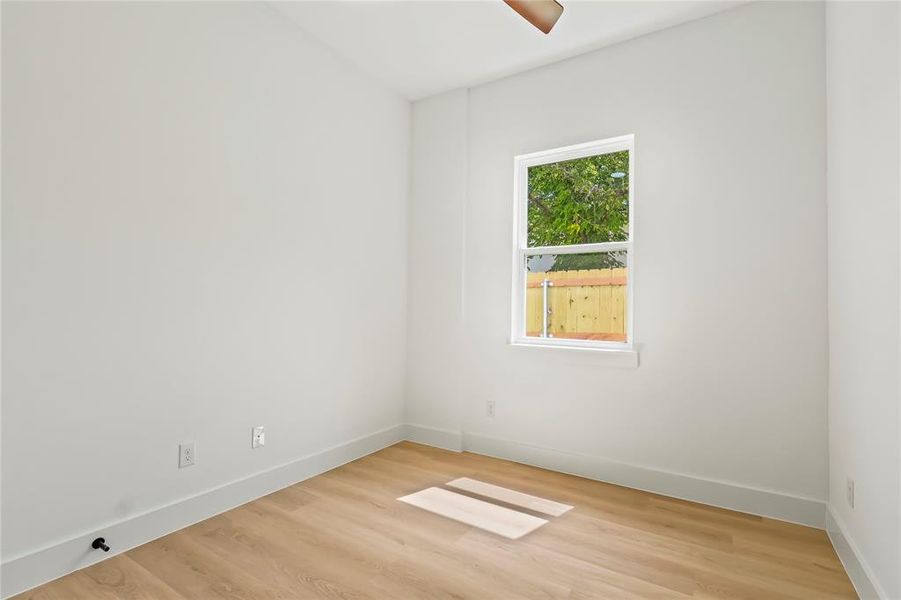 Empty room with light wood-type flooring and baseboards