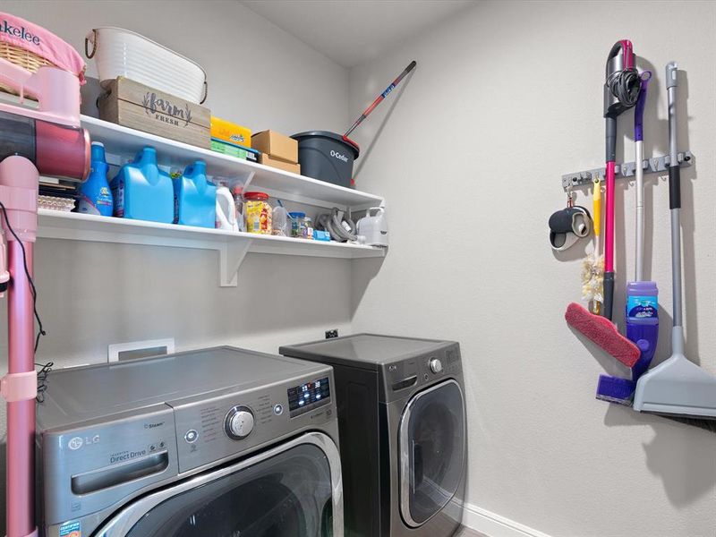 Laundry room with washer and clothes dryer