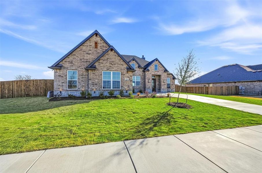Front exterior of a new home in Coyote Crossing, Godley, TX, highlighting curb appeal (Image 27). Front exterior of a new home in Coyote Crossing, Godley, TX, highlighting curb appeal (Image 27).